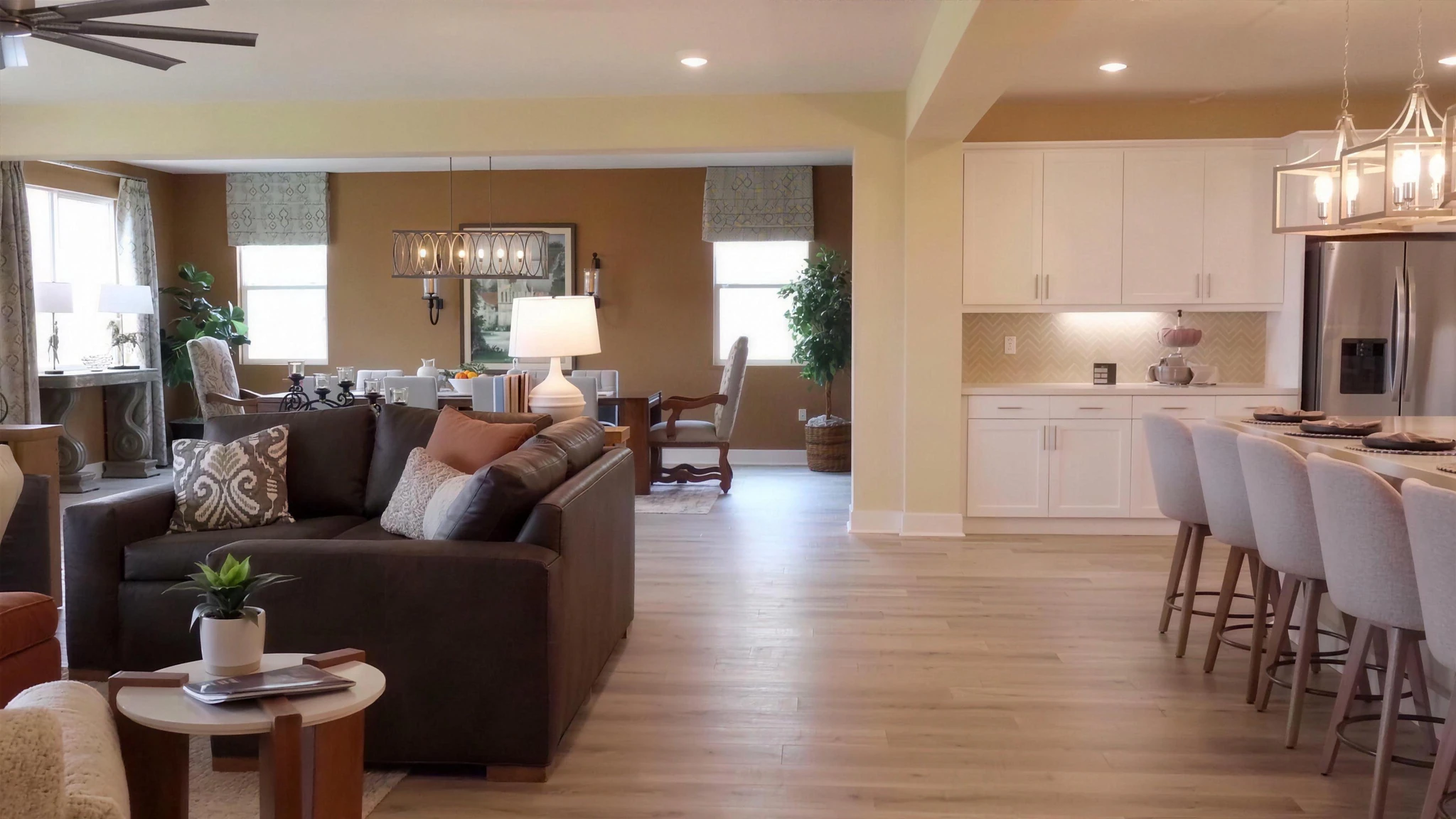 A warm, light-filled RC Hobbs great room opening to the kitchen, with white-oak floors and a quartz island